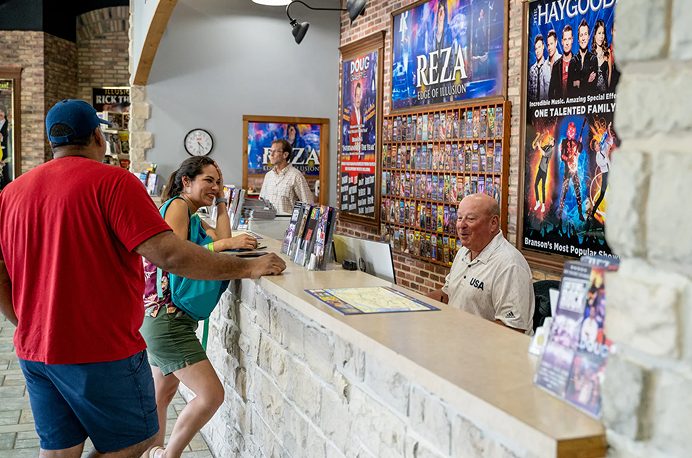 A vacation coordinator helping guests at the welcome center counter