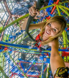 A climber smiling from the ropes course